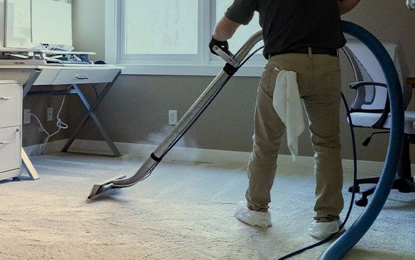 Green Clean team member cleaning carpet