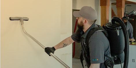 A Green Clean team member cleaning a wall