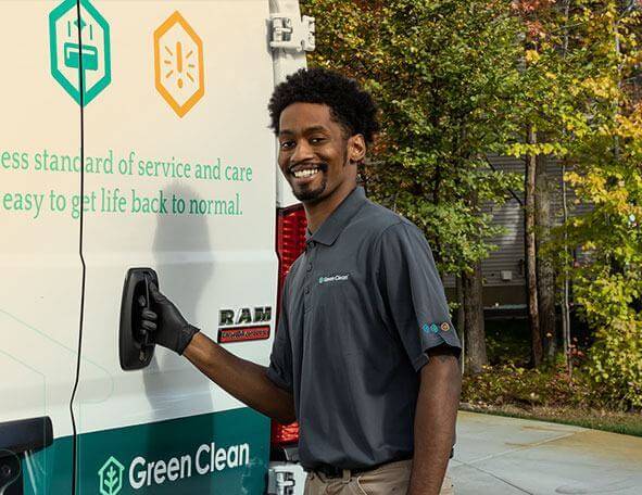 Smiling Green Clean team member opening their truck