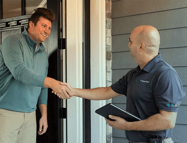 Green Clean team member shaking hands with a customer