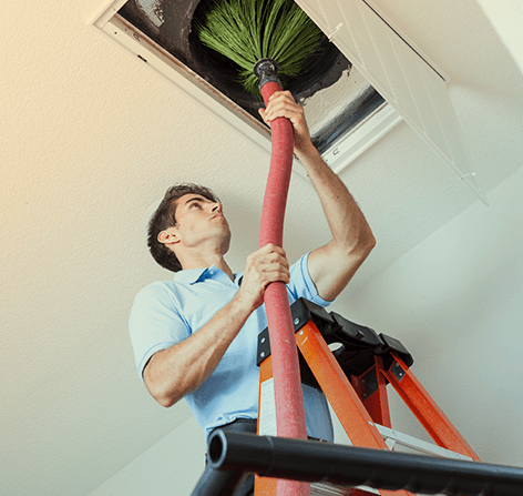 A man cleaning a duct