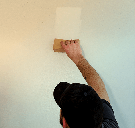 A Green Clean team member cleaning a wall