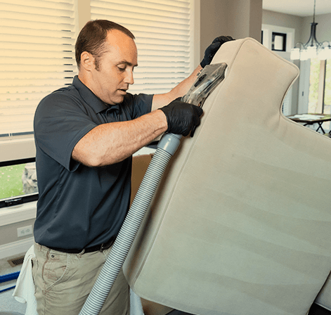 Green Clean team member cleaning upholstery