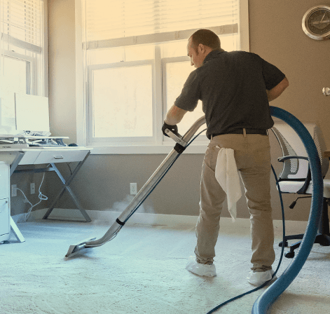 Green Clean team member cleaning carpet