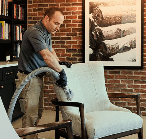 Green Clean team member cleaning upholstery