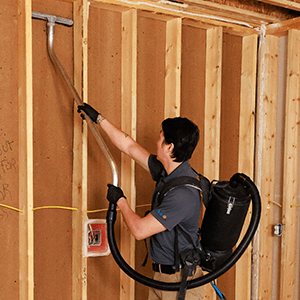 Green Clean team member cleaning the interior of a wall