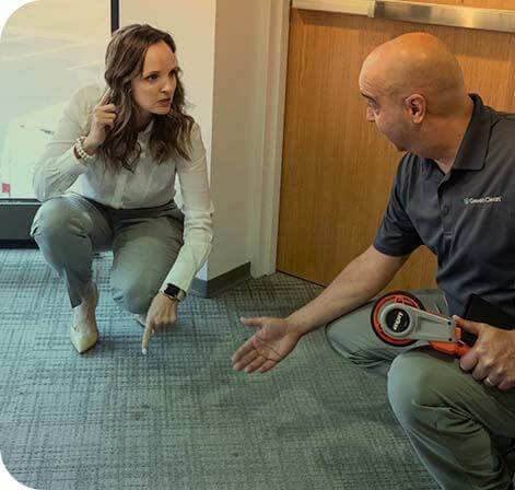 Green Clean Team Member and customer inspecting carpet stains